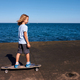 Boy riding a longboard on a pier at sunny day - PhotoDune Item for Sale