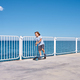 Boy riding a scooter on a pier at sunny day - PhotoDune Item for Sale