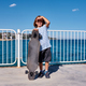 Boy standing with a longboard on a pier at sunny day - PhotoDune Item for Sale