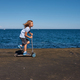 Boy riding a scooter on a pier at sunny day - PhotoDune Item for Sale
