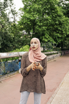 Young Muslim Woman Using Phone