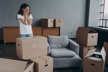 New first home, relocation. Female homeowner feels happiness standing in empty room on moving day