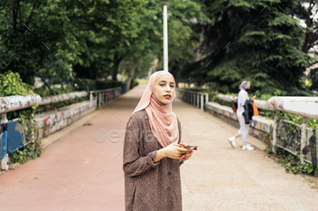 Muslim Woman Using Phone