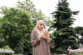 Happy Muslim Woman Using Cellphone