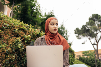 Pretty Muslim Woman Using Laptop