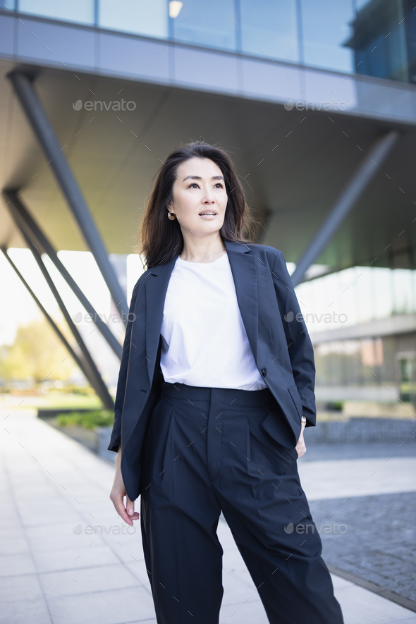 Asian confident business woman in suit smiling, looking up. Job, work aspirational banner