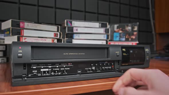 Insert VHS Cassette Into VCR and Push Play Button alt