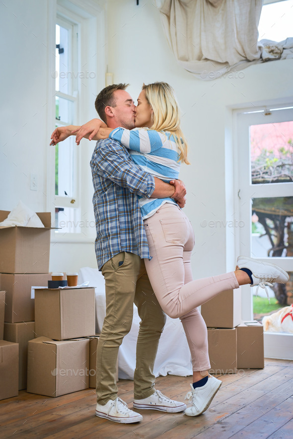 Its a big moment in their lives. Shot of a young couple celebrating their move into a new house.