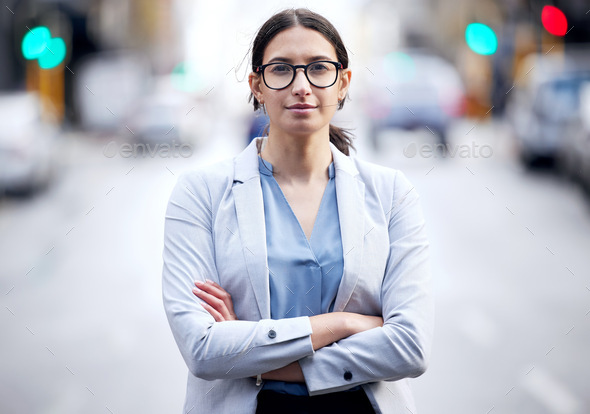 Strength and courage are in. Shot of a young businesswoman standing in the street.