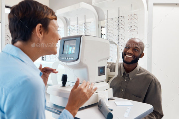 All clear to me. Shot of an optometrist examining her patients eyes with an autorefractor.