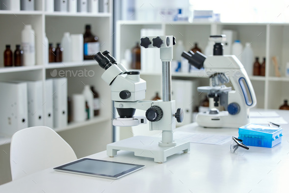 Shot of a microscope and digital tablet on a table in an empty lab