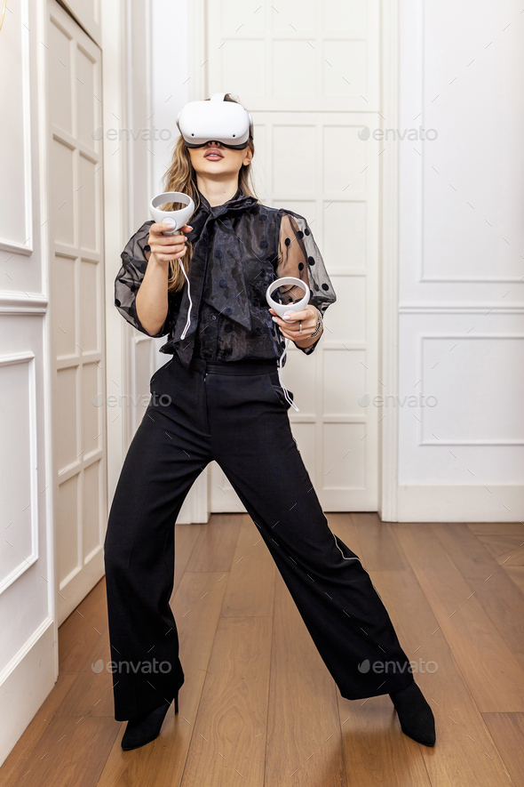 Attractive woman playing with virtual reality at home
