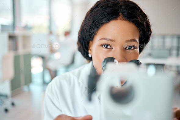 Nothing will remain hidden. Shot of a young scientist using a microscope in a lab.