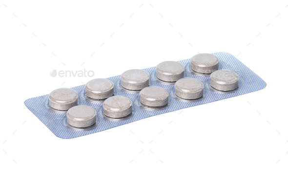 Round pills in blister pack on a white background, close up