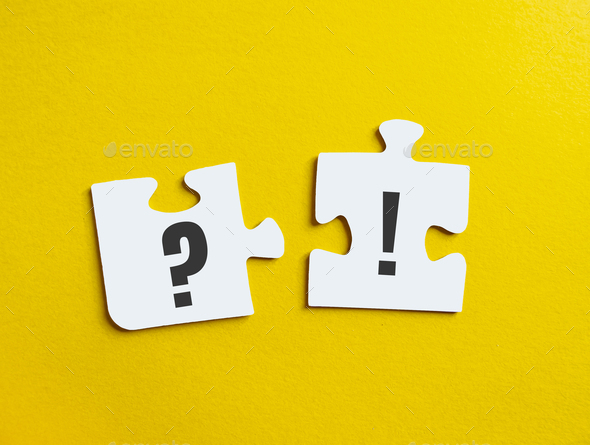 Exclamation point and question mark on puzzle on yellow background.