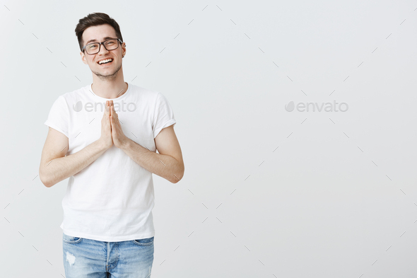 Lend me some money friend. Portrait of charming sincere and cute young male brunet in glasses