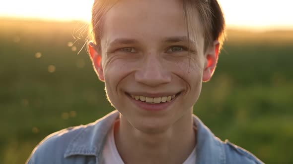 Child boy smiling to camera portrait, caucasian kid, boy with big smile in casual clothes in sunligh