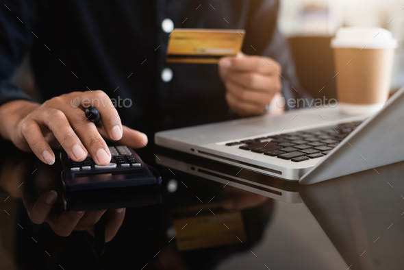 Businessman calculating monthly office expenses and credit card bills payment