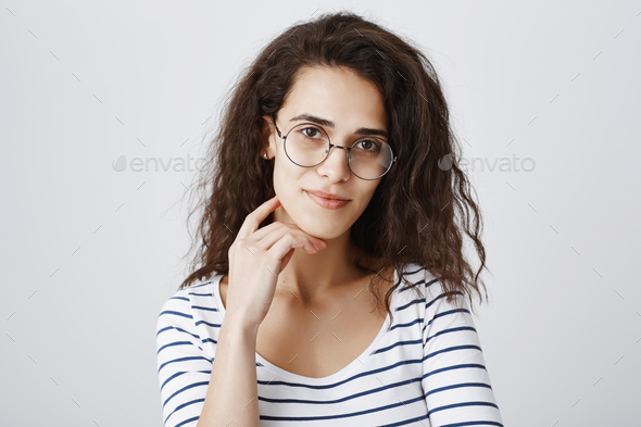 Smart university student taking part in interesting discussion. Portrait of attractive curly-haired