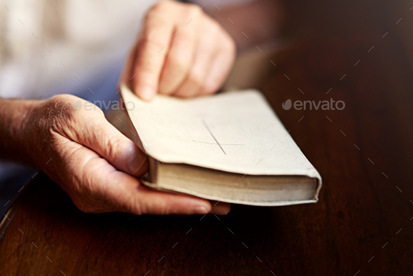One on one time with the word of God. Cropped shot of a man opening a bible.
