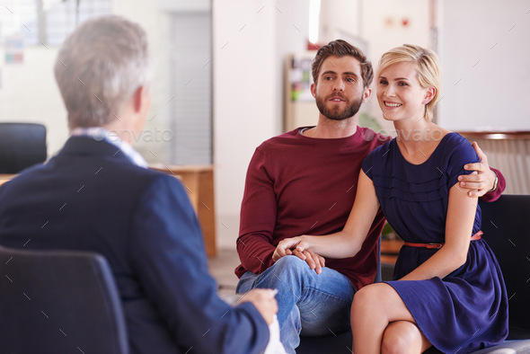 Young couple discussing investment plans with a financial advisor - Stock Photo - Images