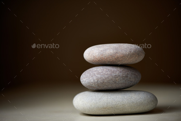 Searching for ones inner balance. Three stones balanced on top of each other in natural light.