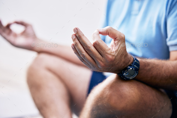 Sharpening the mind-body connection. Closeup shot of an unrecognisable man meditating outdoors.