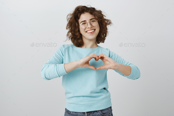 Loving friend thanking for helping out. Portrait of good-looking happy woman with curly hair in