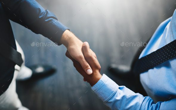 The deal is done. Shot of two unrecognisable businesspeople shaking hands in an office.