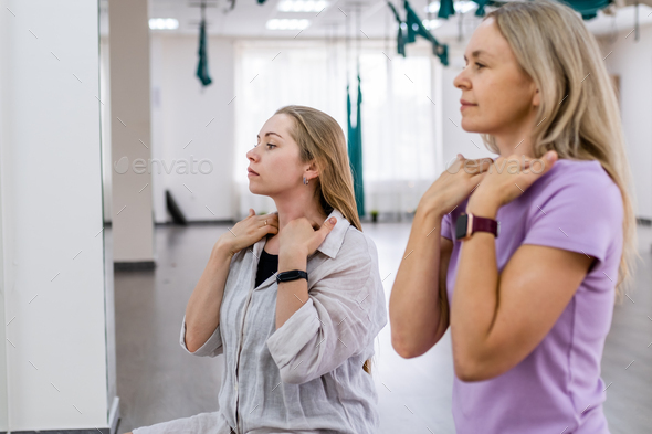 group of women 30 -40 years old do face fitness. concept of facial exercises, physical therapies