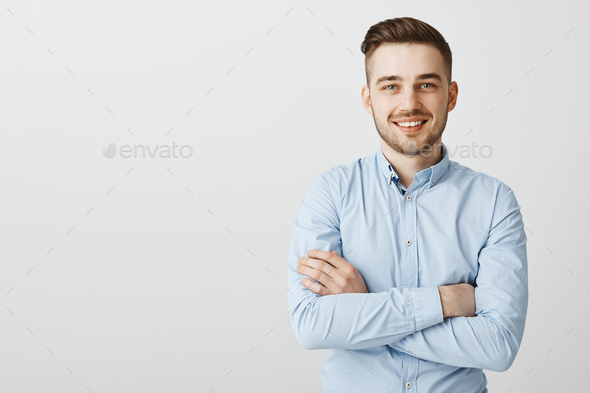 Confident and friendly handsome ambitious man with bristle in blue collar shirt holding hands