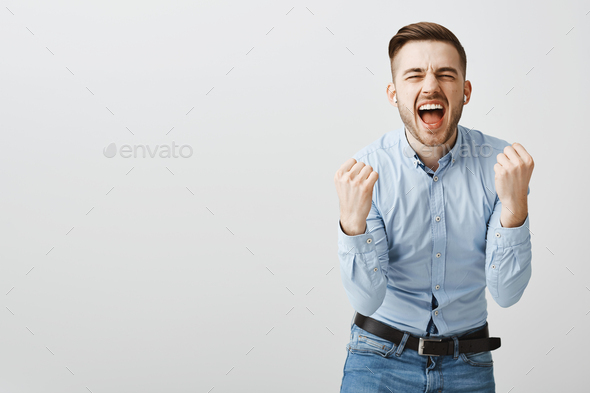 Man singing from heart being carried away with positive emotions while listening favorite song in