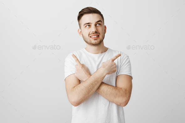 Unsure worried guy feeling nervous making wrong decision standing intense over gray background in