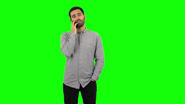 Brunette Guy Is Angrily Talking for Mobile Phone. Green Screen alt