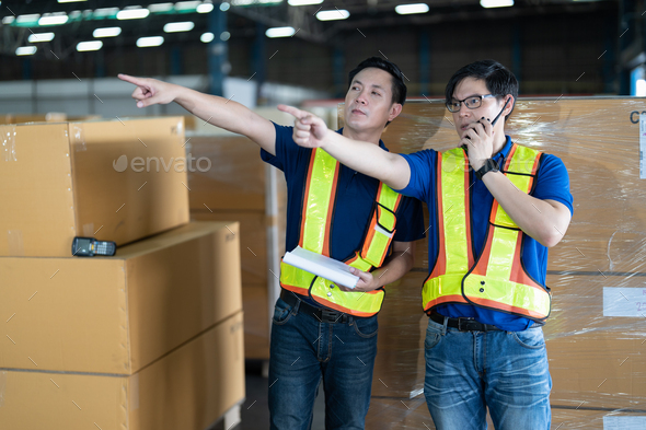 2 man working in the large storage warehouse scan bar code