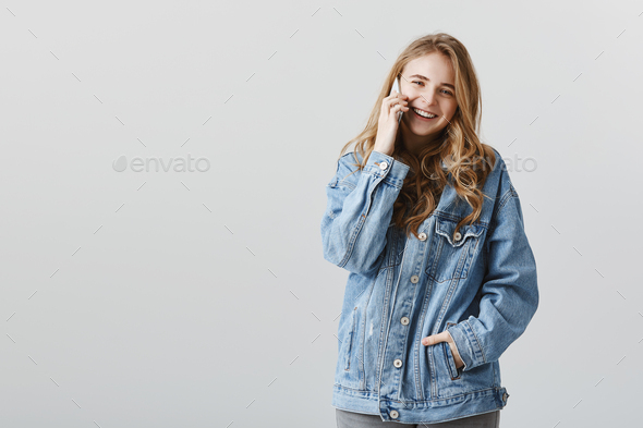 Girlfriend pleased to hear your voice. Portrait of happy carefree european student in denim jacket