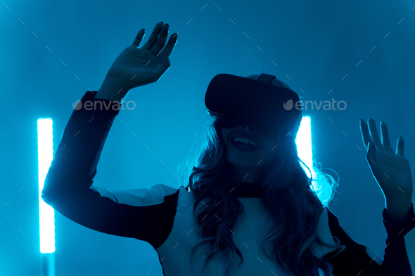 futuristic concept, silhouette of a young woman from the future on a blue background, gesturing