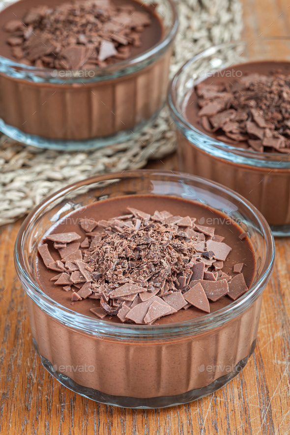 Chocolate Panna Cotta dessert in glass ramekin, wooden background vertical Stock Photo by iuliia_n