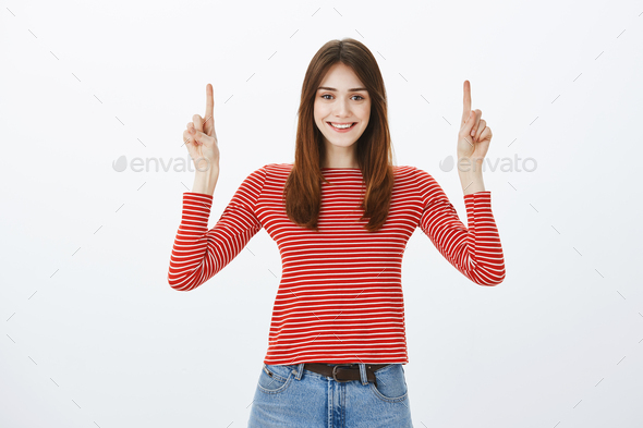 Best copy space for companies. Charming joyful daughter in casual clothes, raising index fingers and
