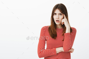 Girl trying to recall date of appointment. Focused questioned attractive woman in casual outfit