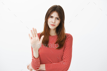 Girl prefers open relationship, hate talking about marriage. Displeased annoyed woman in striped
