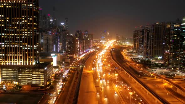 Aerial hyperlapse of a busy highway in Dubai at night, U.A.E. alt