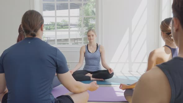 Group of diversity people practice yoga lesson at fitness studio