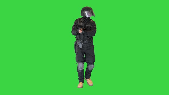 Anti Terrorist or Riot Unit Walking and Aiming with a Pistol on a Green Screen Chroma Key alt