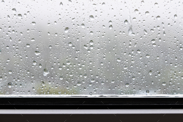raindrops and trickles of rain close up on window - Stock Photo - Images
