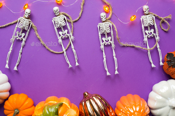 Halloween layout of garland of skeleton on a rope, glowing Jack o Lantern