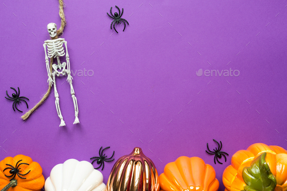 Halloween layout of garland of skeleton on a rope, glowing Jack o Lantern