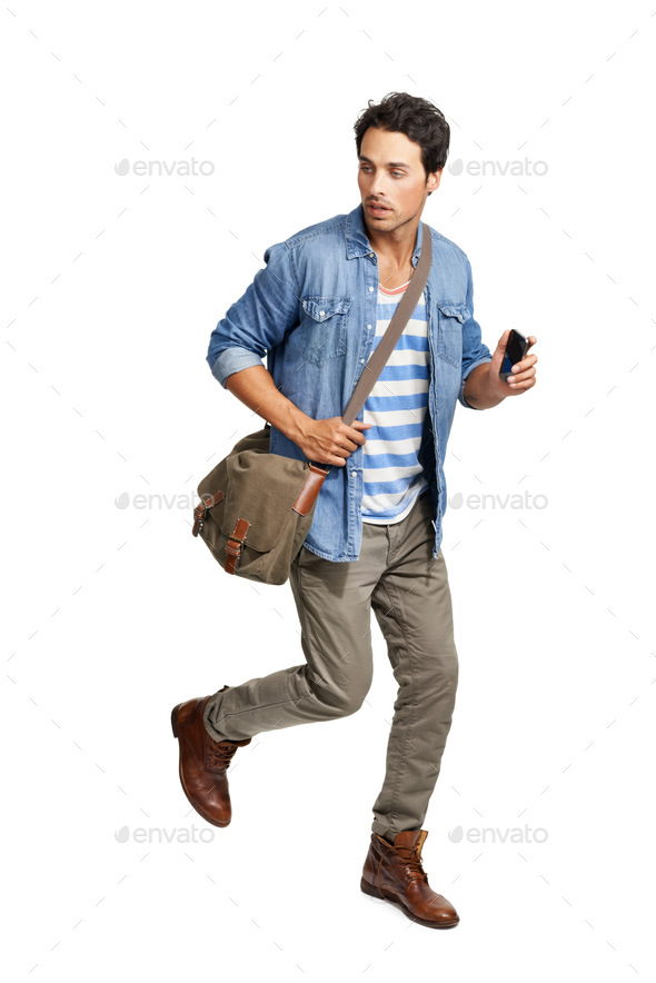 Running late. A handsome young man running against a white background.