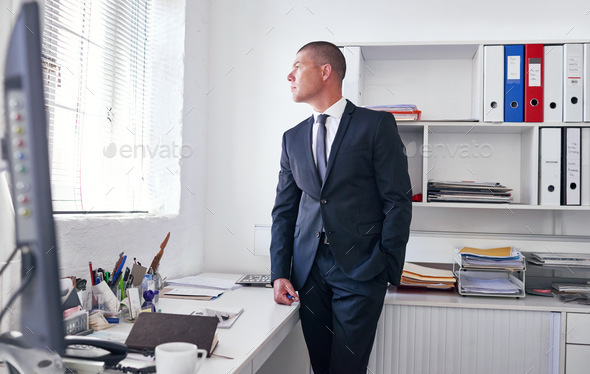 Hes got a vision for this company. Shot of a well-dressed businessman standing in his office.