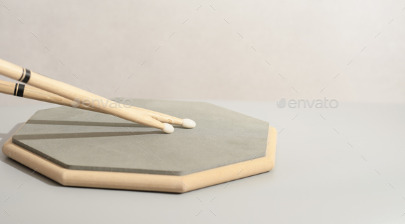 Pair of drumsticks, training pad, practicing for drummers. Copy paste. Music learning concept